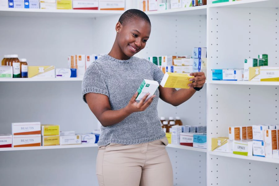 Woman looking at probiotic supplement boxes
